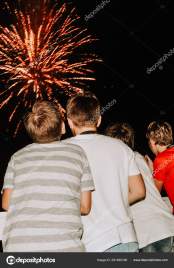 kids watching fireworks colorful four boys backs